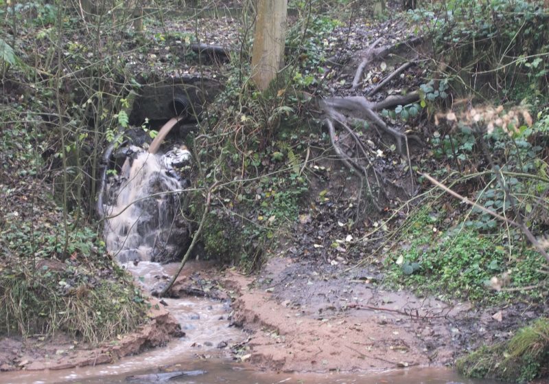 Pollution entering a river from a pipe